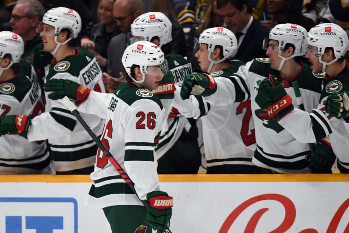 Caption: Feb 29, 2024; Nashville, Tennessee, USA; Minnesota Wild center Connor Dewar (26) celebrates with teammates after a goal during the first period against the Nashville Predators at Bridgestone Arena.